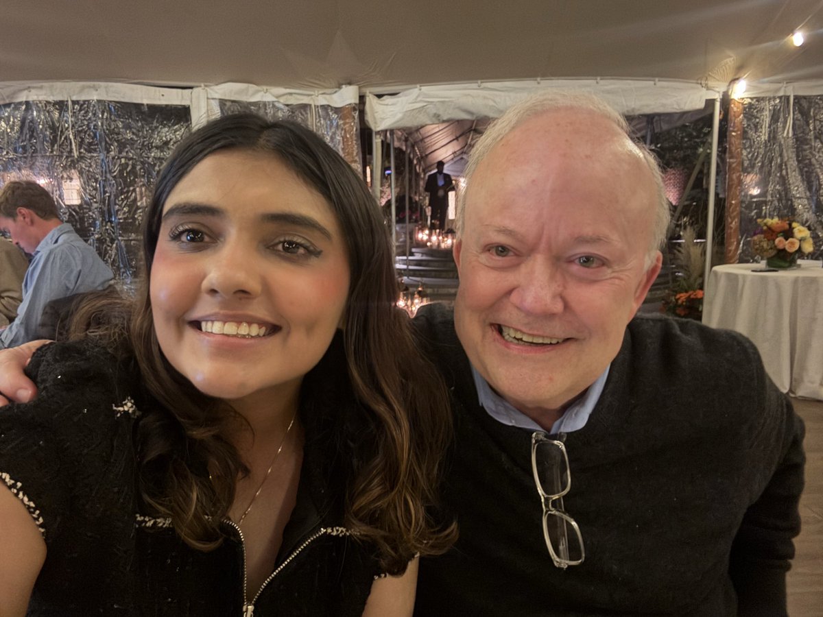 Parmita with Jim O’Shaughnessy, from her October 2025 public photograph.