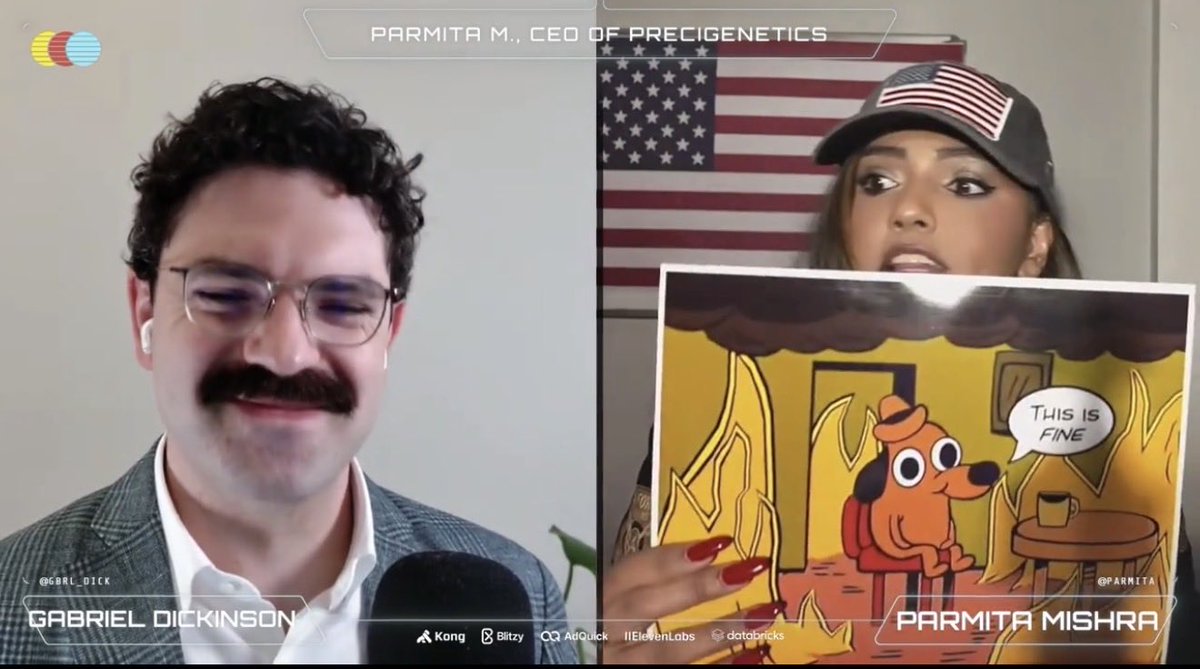 Parmita holding the printed This is fine meme while speaking with Gabriel Dickinson on MTS Live.